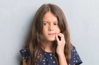 Orthodontist Ellicott City MD Girl In Pain A young girl holding her jaw.