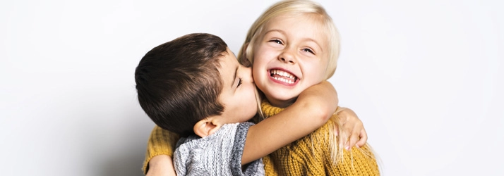 Orthodontist Ellicott City MD Smiling Kids A young boy and girl hugging and smiling.